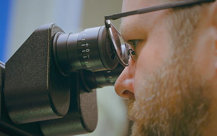 man looking into a microscope