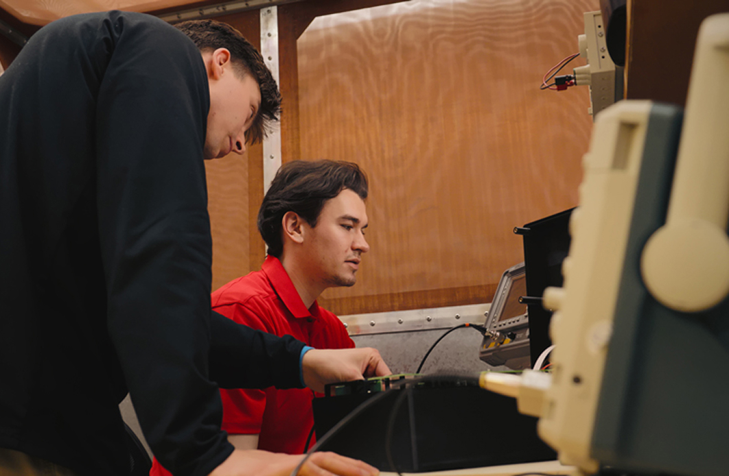 Two Indesign engineers collaborating at a workstation