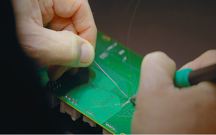 working on the details of a circuit board